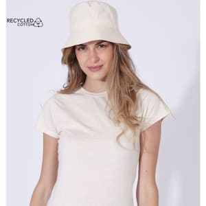 A woman wearing a cream bucket hat made from recycled cotton, paired with a matching cream T-shirt.