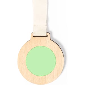 A round wooden medal with a green centre and a cream-coloured ribbon for hanging.