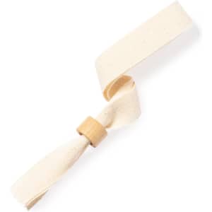 A cream-coloured bracelet made of fabric with a bamboo accent. It features a simple, stylish design.