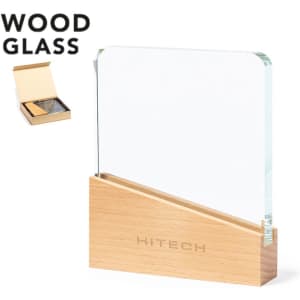 A clear glass plaque with a wooden base, presented in a box, featuring a logo.