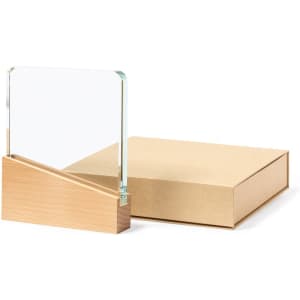 A crystal plaque with a wooden base, accompanied by an elegant brown box.