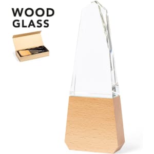A glass trophy with a wooden base, featuring a clear, obelisk-like top. It includes a branded box.