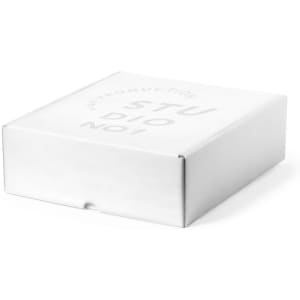 A white cardboard gift box with a flapped lid, featuring a logo on the top.