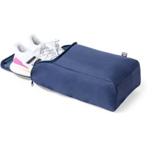 A navy shoe bag featuring a zipped compartment with a pair of white sneakers partially visible inside.