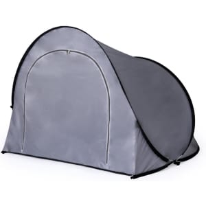 A grey pop-up tent featuring a rounded shape and a zippered entrance, designed for outdoor leisure activities.