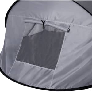 A grey tent with a mesh window and a zippered flap, featuring a rounded shape and black trim.