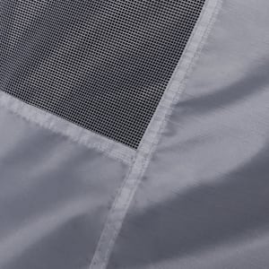 A close-up of a grey tent fabric featuring a mesh panel, showcasing its texture and stitching details.