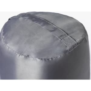 A silver sleeping bag compressed into a cylindrical shape, showcasing its smooth, shiny fabric and stitching details.