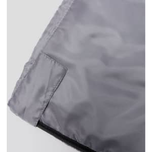 A grey sleeping bag with a smooth surface and zipper detail, featuring a small branding logo.