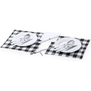 A black and white checkered picnic set with two plates, cutlery, a corkscrew, and a chopping board.