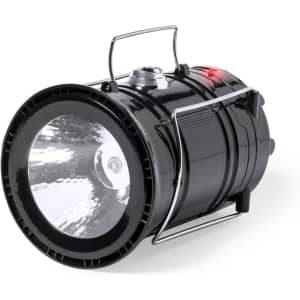 A black power bank lamp with a robust design, featuring a bright light and a handle for easy carrying.