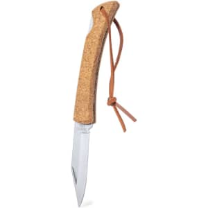 A pocket knife with a silver blade and a cork handle, featuring a leather lanyard. It has a logo on the handle.