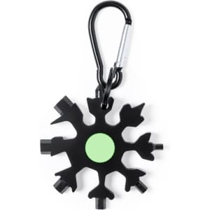 A black multitool shaped like a snowflake, featuring various tools and a green circle, attached to a carabiner.