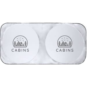 A rectangular sunshade featuring two circular sections with a logo and a design of a cabin against a snowy backdrop.