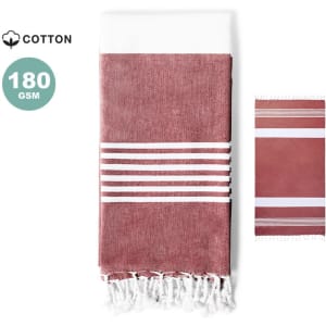 A cotton towel pareo in rust red and white, featuring striped patterns and fringed edges, with a logo present.