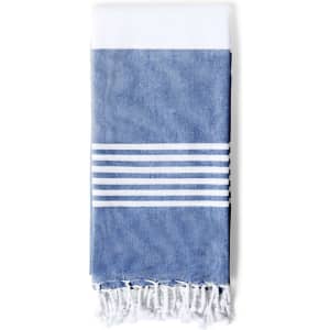 A blue and white striped towel with fringed edges, featuring a solid white top section and blue bottom.