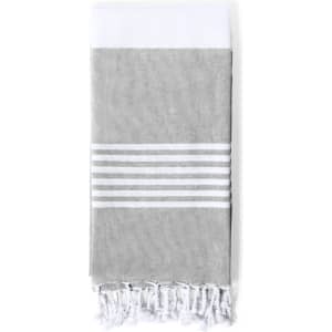 A grey towel pareo with white stripes and fringed edges, featuring a white top section and a logo.