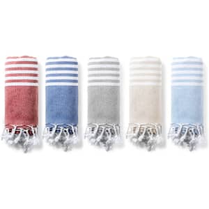 Five rolled towels in red, blue, grey, and beige with striped patterns and tasselled edges.