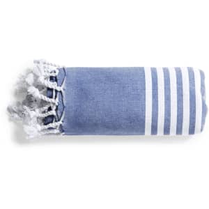 A folded blue towel pareo with white stripes and tassels at one end, featuring a logo.