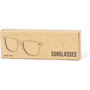 A cardboard box containing Prakay sunglasses featuring a sketch design on the front. The sunglasses appear to be stylish and modern.