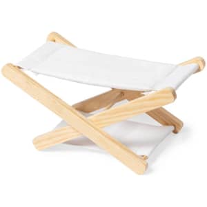 A wooden headrest with a white fabric surface, featuring a folded and collapsible design. Brand logo visible.