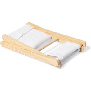 A wooden headrest with white fabric cushions, ideal for home relaxation. It features a simple, natural design.