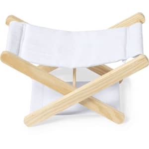 A compact headrest with a white fabric and wooden frame, featuring a crossed design for storage.