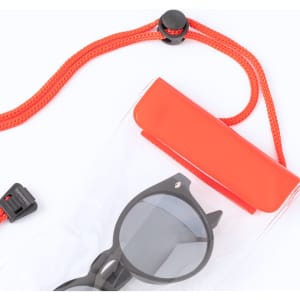 A clear dry bag in bright red, featuring a black pair of sunglasses and a securing strap.