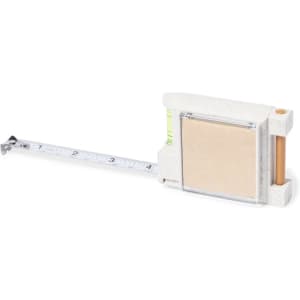 A multifunction tape measure in cream with a retractable silver tape and a wooden pencil holder.