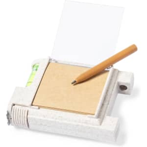 A multifunction tape measure in beige with a level and a notepad holder, accompanied by a pen.