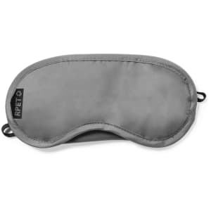 A grey travel eye mask featuring a soft fabric surface and elastic straps for comfort, with a logo on one side.