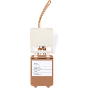 A brown luggage tag with a transparent top, featuring a slot for personal information and a small logo.