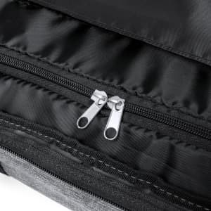 A close-up of the zippered opening of a black and grey wheeled bag, featuring silver zipper pulls.