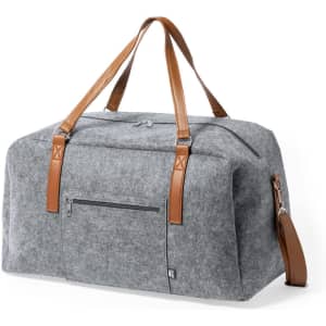 A grey felt bag with brown leather handles and a detachable shoulder strap, featuring a front zip pocket.