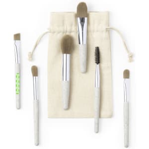 A set of six eyeshadow applicators in various sizes with grey and white handles, presented in a natural fabric pouch.