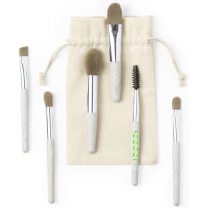 A set of six eyeshadow applicators with beige handles, displayed alongside a natural fabric pouch.
