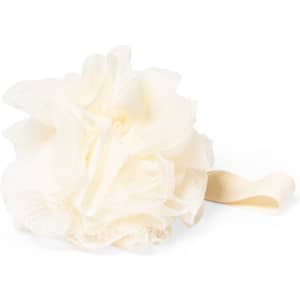A cream bath sponge shaped like a flower with a fabric strap. It features a soft, textured surface.