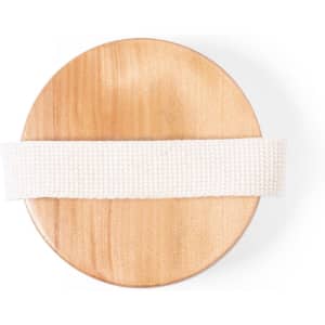 A wooden exfoliating massage brush with a white textile strap on top. The base is smooth and circular.