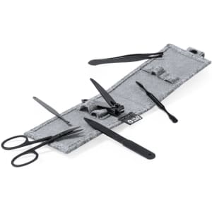 A grey manicure set featuring black tools including scissors, nail clippers, and cuticle pushers, all neatly organised.
