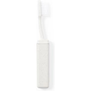 A white toothbrush with a textured handle and a matching protective case, featuring branding.