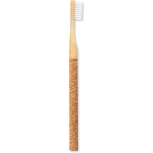 A bamboo toothbrush with a cork handle and white bristles, featuring a logo on the handle.