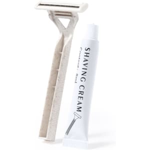 A shaving kit set featuring a white razor and a white tube of shaving cream. The kit has a minimalist design.
