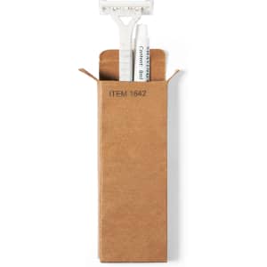 A shaving kit set in a brown cardboard box, featuring a razor with a white handle inside.