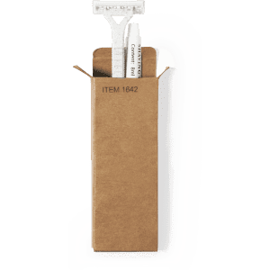 A shaving kit set in a cardboard box, featuring a razor and shaving cream. The packaging is brown.