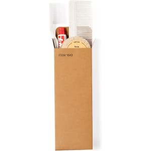 A brown cardboard box containing a comb, soap, and other toiletry accessories. It has a branding logo on the side.