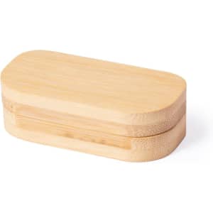 A bamboo pillbox with an oval shape and a natural wood finish. It features a simple design and has a logo.