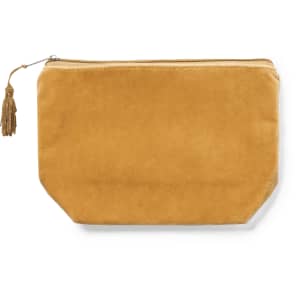 A mustard yellow toiletry bag with a zip closure and a decorative tassel. It has a smooth, soft texture and a logo.