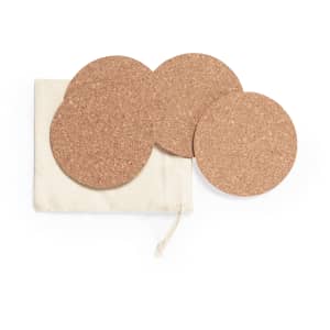 A set of four round cork coasters in a fabric pouch. The coasters are natural brown in colour.