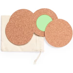 A set of cork coasters in various sizes with a green circular design, packaged in a cloth pouch.