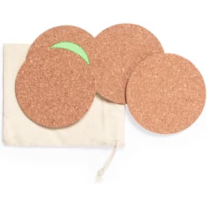 A set of four round cork coasters in a natural fabric pouch, featuring a vibrant green accent on one coaster.